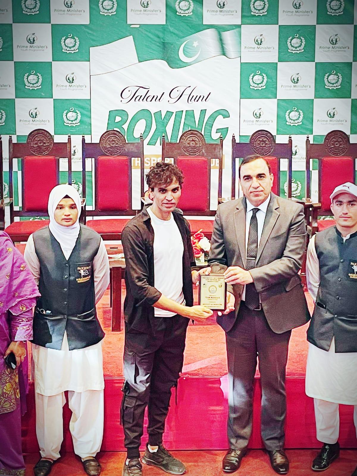 Coach receiving a team award at the Prime Minister's Youth Programme Talent Hunt boxing tournament