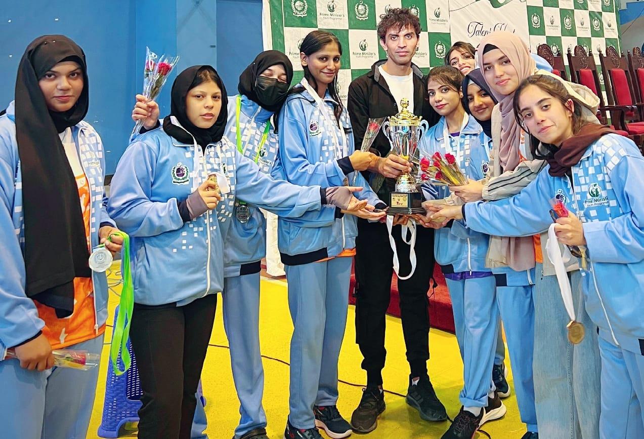 Women's boxing squad from the gym holding the winners' trophy